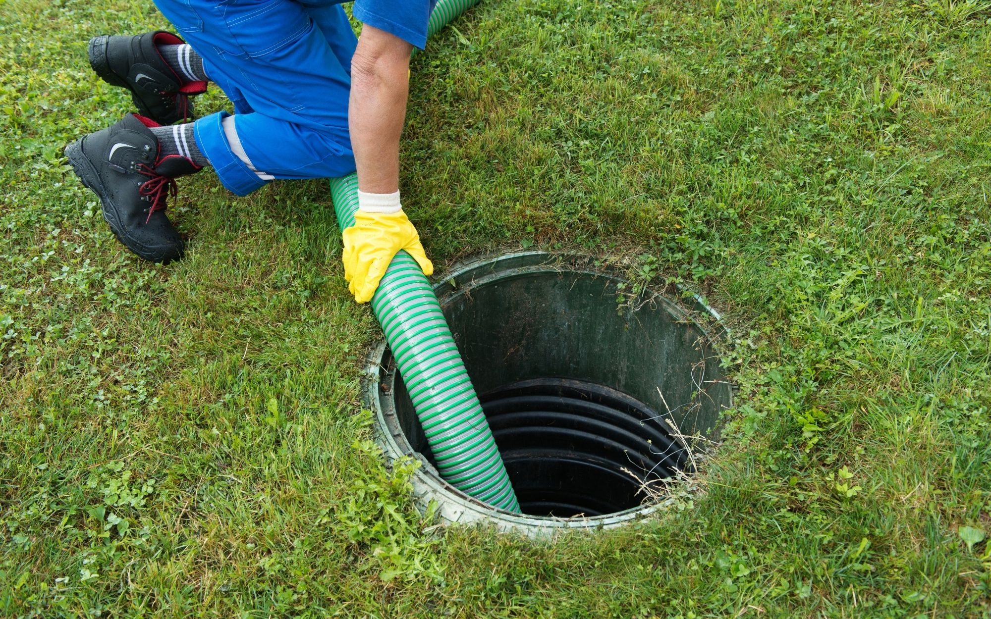 A tube is coming out of a hole in the ground where the septic tank is
