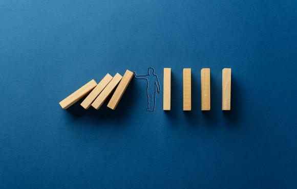 Graphic of person holding up dominos
